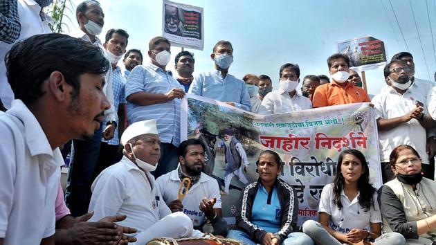 Protestors hold placards and banners outside the district collector’s office in Sangli on Thursday.(Uday Deolekar/HT) Protestors hold placards and banners outside the district collector’s office in Sangli on Thursday.(Uday Deolekar/HT)