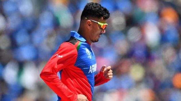 Afghanistan's Mujeeb Ur Rahman walks back to his fielding position.(AFP)