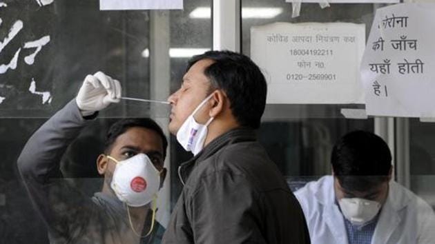 A health worker collects a swab sample for coronavirus test in Noida.(HT photo) A health worker collects a swab sample for coronavirus test in Noida.(HT photo)