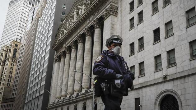 An NYPD officer walks along a sparsely populated Wall Street in the Manhattan borough of New York.(Representational Image / AP) An NYPD officer walks along a sparsely populated Wall Street in the Manhattan borough of New York.(Representational Image / AP)