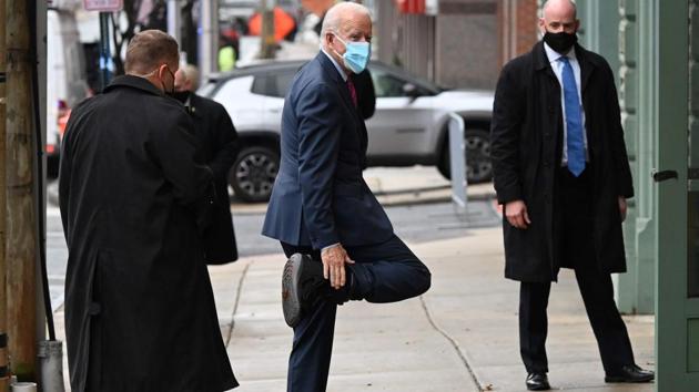 US President-elect Joe Biden playfully shows off his boot as he arrives at The Queen in Wilmington, US.(AFP) US President-elect Joe Biden playfully shows off his boot as he arrives at The Queen in Wilmington, US.(AFP)
