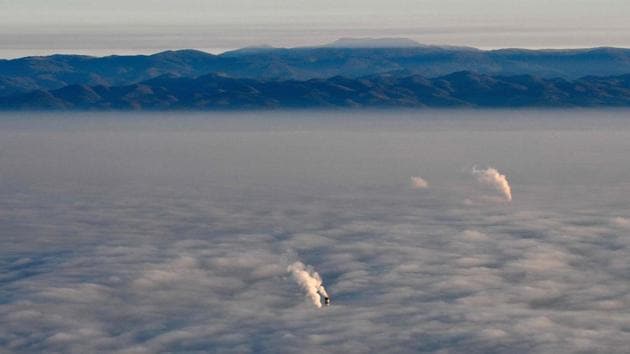 Smoke billows from chimneys as they rise above clouds, seen from Vitosha mountain in Sofia, Bulgaria on November 27. (Nikolay Doychinov / AFP) Smoke billows from chimneys as they rise above clouds, seen from Vitosha mountain in Sofia, Bulgaria on November 27. (Nikolay Doychinov / AFP)