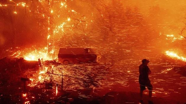 A man is spotted at his home as the Bond Fire burns though the Silverado community in Orange County, California, US on December 3. (Noah Berger / AP) A man is spotted at his home as the Bond Fire burns though the Silverado community in Orange County, California, US on December 3. (Noah Berger / AP)