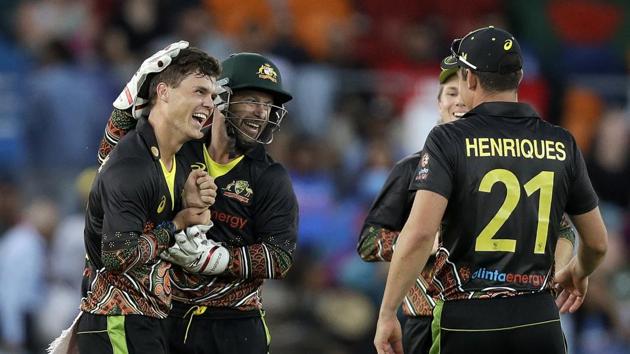 Australia's Mitchell Swepson, left, is congratulated by teammates after taking the wicket of India's Virat Kohli for 9 runs during their T20 international cricket match at Manuka Oval, in Canberra.(AP)