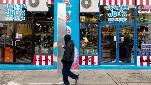 A passerby touches the monolith standing outside Grandpa Joe's Candy Shop in Pittsburgh, Pennsylvania.(REUTERS)