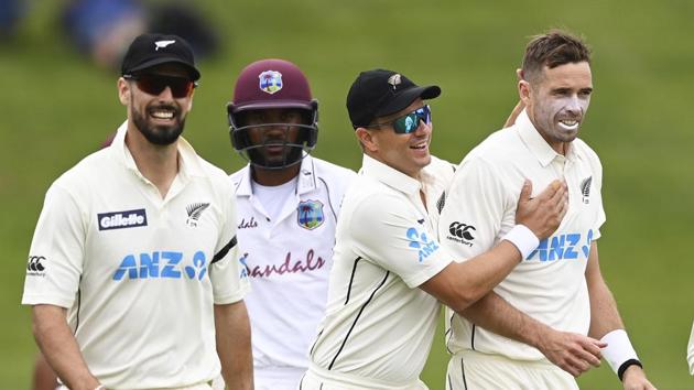 New Zealand's Tim Southee, right, is congratulated by teamates after dismissing the West Indies' John Campbell during play on day three of their first cricket test in Hamilton, New Zealand. (AP)