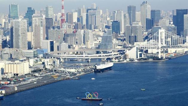The five Olympic rings are transported to be positioned on a barge in Tokyo, Japan on December 1. They were removed for maintenance four months ago shortly after the Tokyo Olympics were postponed until next year due to the Covid-19 outbreak. (Kyodo News via AP) The five Olympic rings are transported to be positioned on a barge in Tokyo, Japan on December 1. They were removed for maintenance four months ago shortly after the Tokyo Olympics were postponed until next year due to the Covid-19 outbreak. (Kyodo News via AP)