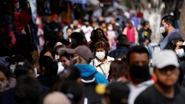 People are seen on the street as the coronavirus disease (Covid-19) outbreak continues in Mexico City, Mexico.(Reuters)