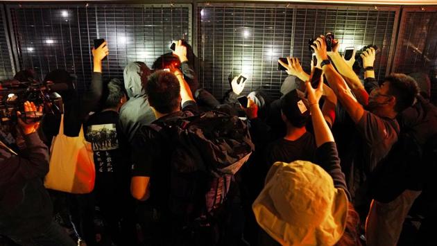 Supporters surround a police van after the sentencing of pro-democracy activists Joshua Wong, Agnes Chow and Ivan Lam for participating in a June 2019 protest, outside the police headquarters, at West Kowloon Magistrates’ Courts in Hong Kong on December 2. (Lam Yik / REUTERS) Supporters surround a police van after the sentencing of pro-democracy activists Joshua Wong, Agnes Chow and Ivan Lam for participating in a June 2019 protest, outside the police headquarters, at West Kowloon Magistrates’ Courts in Hong Kong on December 2. (Lam Yik / REUTERS)