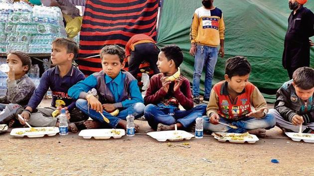 Children from nearby shanties enjoy a meal at the Singhu border (Delhi-Haryana border).(Sourced)