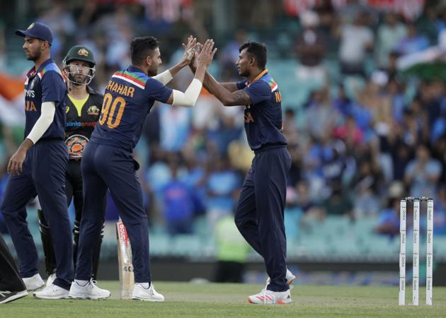India's T Natarajan, right, celebrates with teammates the dismissal of Australia's D'Arcy Short during the second T20 international cricket match between Australia and India at the Sydney Cricket Ground in Sydney, Australia, Sunday, Dec. 6, 2020. (AP Photo/Rick Rycroft) (AP)