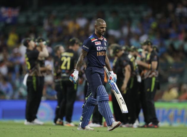 India's Shikhar Dhawan walks off the field after being dismissed by Australia's Adam Zampa during the second T20 international cricket match between Australia and India at the Sydney Cricket Ground in Sydney, Australia, Sunday, Dec. 6, 2020. (AP Photo/Rick Rycroft) (AP)