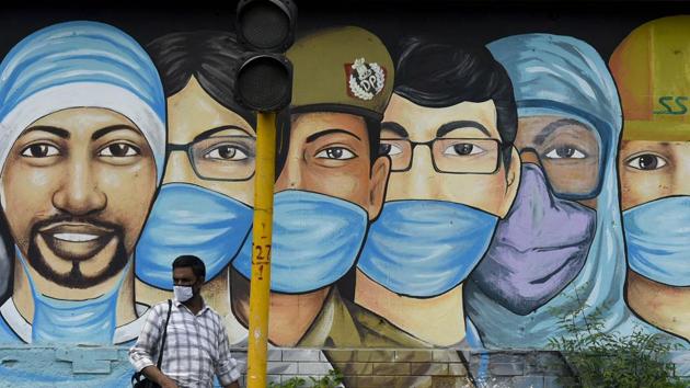 File photo: A man standing in front of a mural of Covid-19 frontline workers. (Biplov Bhuyan/HT PHOTO) File photo: A man standing in front of a mural of Covid-19 frontline workers. (Biplov Bhuyan/HT PHOTO)