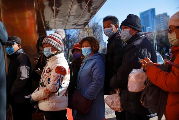 People line up to buy takeaway food, following the outbreak of the coronavirus disease (Covid-19), in Beijing, China. (Reuters) People line up to buy takeaway food, following the outbreak of the coronavirus disease (Covid-19), in Beijing, China. (Reuters)