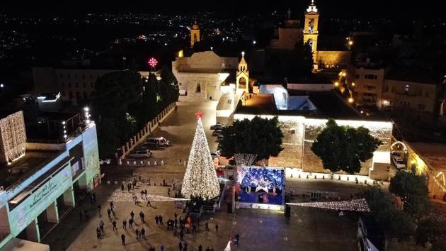 Palestinians light Christmas tree at Manger Square outside the Church of the Nativity, amid the coronavirus disease (COVID-19) outbreak, in Bethlehem in the Israeli-occupied West Bank.(REUTERS) Palestinians light Christmas tree at Manger Square outside the Church of the Nativity, amid the coronavirus disease (COVID-19) outbreak, in Bethlehem in the Israeli-occupied West Bank.(REUTERS)