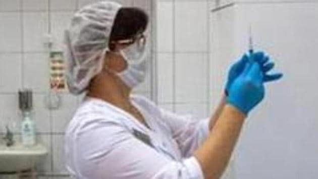 A health worker prepares a needle to inject the 'Gam-COVID-Vac', also known as 'Sputnik V', COVID-19 vaccine, developed by the Gamaleya National Research Center for Epidemiology and Microbiology and the Russian Direct Investment Fund (RDIF), during a trial at the City Clinic #2 in Moscow, Russia.(Bloomberg)
