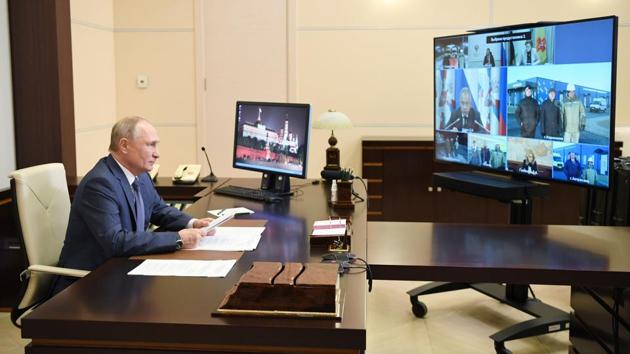 Russian President Vladimir Putin participates in the opening of multi-purpose medical centres of the Russian Defence Ministry via video conference at the Novo-Ogaryovo state residence outside Moscow on December 2. Putin has ordered a nationwide voluntary vaccination programme to begin next week. He said Russia will have produced 2 million vaccine doses within the next few days, Reuters reported. (Alexey Nikolsky / AFP) Russian President Vladimir Putin participates in the opening of multi-purpose medical centres of the Russian Defence Ministry via video conference at the Novo-Ogaryovo state residence outside Moscow on December 2. Putin has ordered a nationwide voluntary vaccination programme to begin next week. He said Russia will have produced 2 million vaccine doses within the next few days, Reuters reported. (Alexey Nikolsky / AFP)