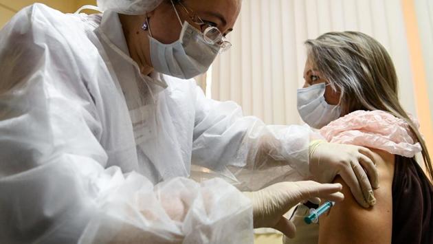 A nurse vaccinates a woman with Sputnik V at a clinic in Moscow on December 5. Among the first people signing up Sputnik V roll-out, Nadezhda Ragulina, an administrator at a Moscow clinic, told Reuters she wanted the vaccine as she had witnessed many Covid-19 patients. (Kirill Kudryavtsev / AFP) A nurse vaccinates a woman with Sputnik V at a clinic in Moscow on December 5. Among the first people signing up Sputnik V roll-out, Nadezhda Ragulina, an administrator at a Moscow clinic, told Reuters she wanted the vaccine as she had witnessed many Covid-19 patients. (Kirill Kudryavtsev / AFP)
