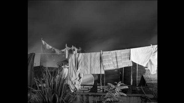 Dakpa’s photos reveal the physical spaces of the hotel, its guest rooms, dining room, the family’s cat on a flight of stairs; as well as signs of daily working life there: sheets hanging out to dry, clipping plants in the garden, his parents engaged in various tasks. (Tenzing Dakpa)