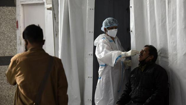A health worker collects a swab sample from a traveller to test for Covid-19 infection at Hazrat Nizamuddin railway station in New Delhi on December 7. While commenting on the declining Covid-19 trend, Delhi chief minister Arvind Kejriwal tweeted, “I am glad that the third wave of Covid-19 also seems to be getting weak. Delhi fought a very difficult war against Covid-19,” HT reported. (Biplov Bhuyan / HT Photo) A health worker collects a swab sample from a traveller to test for Covid-19 infection at Hazrat Nizamuddin railway station in New Delhi on December 7. While commenting on the declining Covid-19 trend, Delhi chief minister Arvind Kejriwal tweeted, “I am glad that the third wave of Covid-19 also seems to be getting weak. Delhi fought a very difficult war against Covid-19,” HT reported. (Biplov Bhuyan / HT Photo)