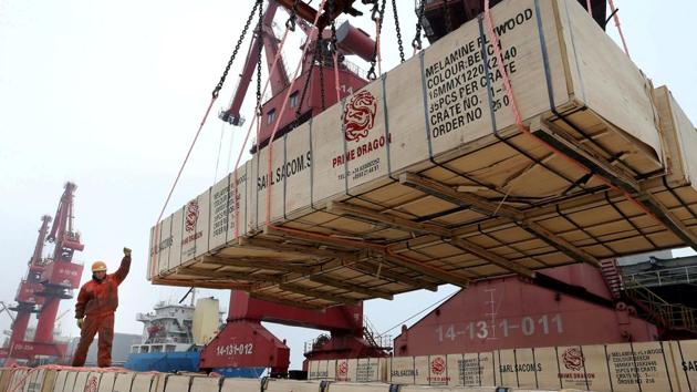 A worker gestures as a crane lifts goods for export onto a cargo vessel at a port in Lianyungang, Jiangsu province, China.(Reuters file) A worker gestures as a crane lifts goods for export onto a cargo vessel at a port in Lianyungang, Jiangsu province, China.(Reuters file)