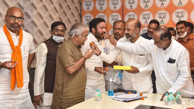 Telangana State BJP President Bandi Sanjay Kumar, Union Minister of State for Home Affairs G Kishan Reddy along with other leaders celebrate the Greater Hyderabad Municipal Corporation election results in Hyderabad.(PTI)
