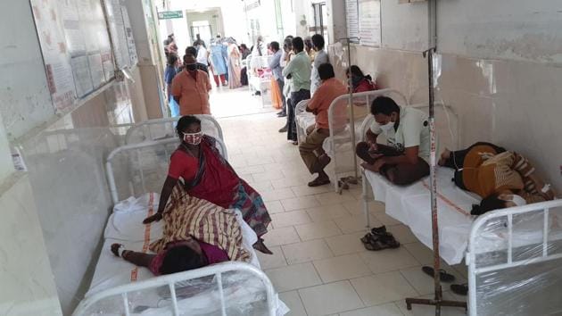 Patients and their attendants at the district government hospital in Eluru, Andhra Pradesh after hundreds have been hospitalized due to an unidentified illness.(AP)