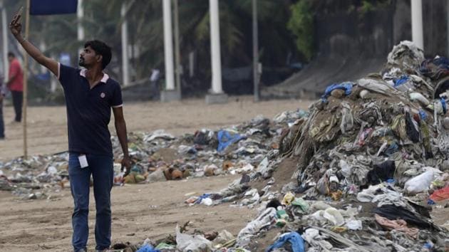 A man takes a selfie in front of a heap of garbage on the shores the Arabian Sea in Mumbai.(AP file) A man takes a selfie in front of a heap of garbage on the shores the Arabian Sea in Mumbai.(AP file)