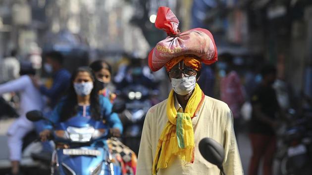 Between November 1-18, as many as 70,955 people were fined for not wearing masks, the same decreased to 26,845 in the latter half of the month after the penalty amount was increased by four times. (AP Photo. Representative image) Between November 1-18, as many as 70,955 people were fined for not wearing masks, the same decreased to 26,845 in the latter half of the month after the penalty amount was increased by four times. (AP Photo. Representative image)