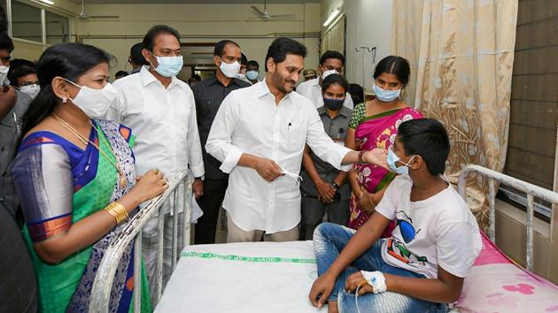 Andhra Pradesh chief minister YS Jagan Mohan Reddy meets patients who fell ill in Eluru town of Godavari district on Monday.(PTI Photo)