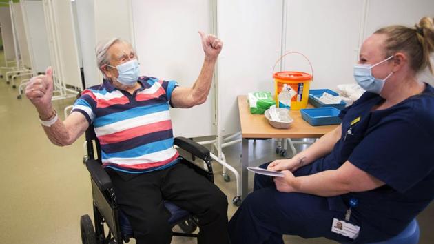 Henry (Jack) Vokes, 98, reacts receiving the Pfizer-BioNTech vaccine at Southmead Hospital in Bristol, England on December 8. The vaccine, however, remains experimental. While it seems to prevent people from getting sick, it is still unclear how long that protection lasts. (Graeme Robertson / Pool via AP)