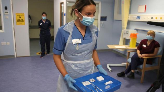 Deputy charge nurse Katie McIntosh arrives to administer the first of two Pfizer-BioNTech Covid-19 vaccine shots to staff, at the Western General Hospital in Edinburgh, Scotland on December 8. In England, the vaccine will be delivered at 50 hospital hubs in the first wave of the program. Northern Ireland, Scotland and Wales are making their own plans under the UK’s system of devolved administration. (Andrew Milligan / Pool / AFP)