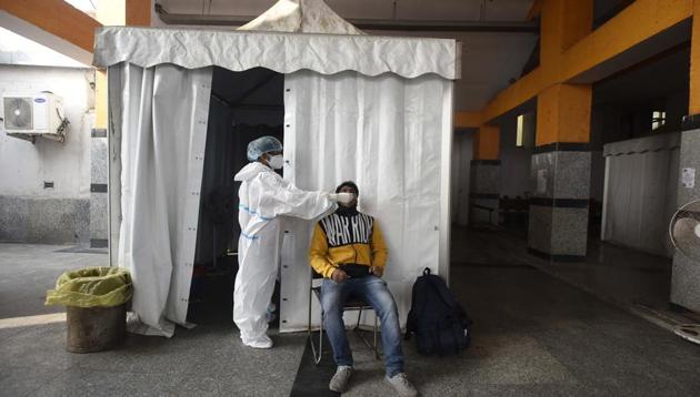 A medical worker in PPE kit collects a swab sample from a passenger to test for Covid-19 infection before boarding a train at Hazrat Nizamuddin railway station, in New Delhi, India, on Monday, December 7, 2020. (Biplov Bhuyan/HT photo) A medical worker in PPE kit collects a swab sample from a passenger to test for Covid-19 infection before boarding a train at Hazrat Nizamuddin railway station, in New Delhi, India, on Monday, December 7, 2020. (Biplov Bhuyan/HT photo)