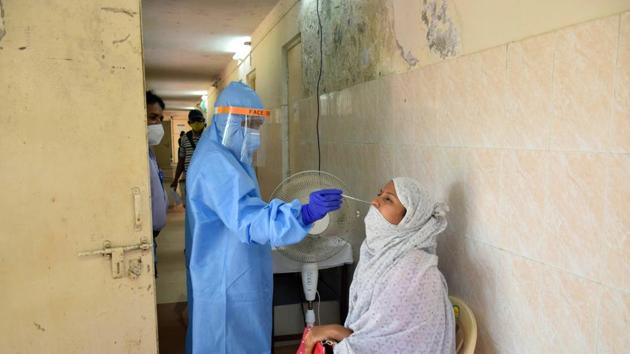 A PMC health worker taking swab of a resident at Pune, on December 3, (HT PHOTO) A PMC health worker taking swab of a resident at Pune, on December 3, (HT PHOTO)