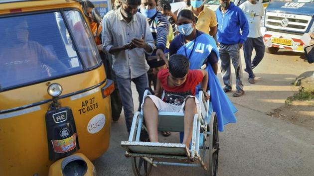 A young patient is brought in a wheelchair to the district government hospital in Eluru. More than 500 have been hospitalized due to an unidentified illness in this town.(AP)