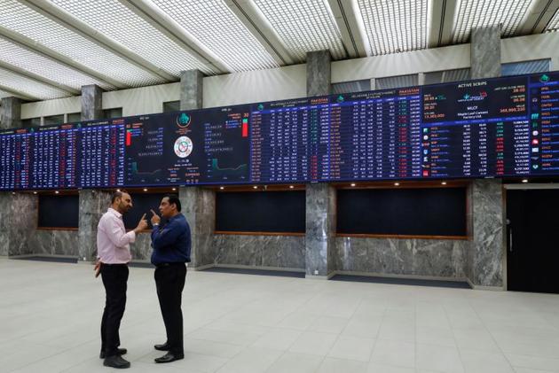 Men talk as they stand in front of electronic board displaying share market prices. (Reuters/ File photo) Men talk as they stand in front of electronic board displaying share market prices. (Reuters/ File photo)