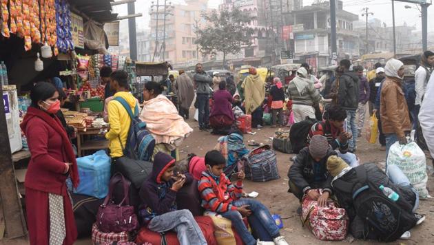 Passengers wait for alternate transport services after bus services were suspended at Patna’s Mithapur bus stand on Tuesday in solidarity with farmers' call for Bharat Bandh against new farm laws.