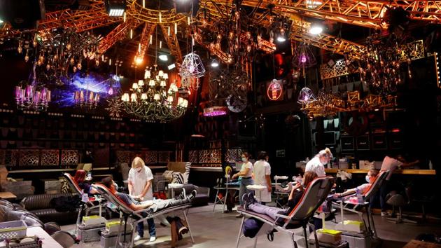 People give blood on the stage of the closed MAD (Moulin a Danse) night club during the outbreak of the coronavirus disease (COVID-19) in Lausanne, Switzerland. (REUTERS)