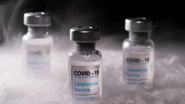 Vials labelled "COVID-19 Coronavirus Vaccine" are placed on dry ice in this illustration taken, December 4, 2020. REUTERS/Dado Ruvic/Illustration