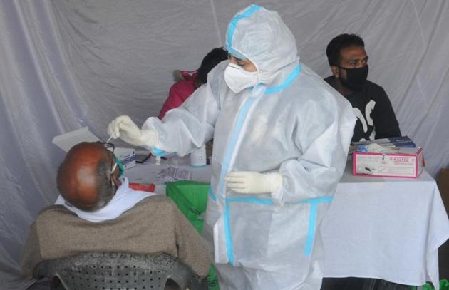 A passenger giving sample for Covid-19 testing at a mobile camp set up at the ISBT in Sector 17, Chandigarh, on Wednesday. (Keshav Singh/HT) A passenger giving sample for Covid-19 testing at a mobile camp set up at the ISBT in Sector 17, Chandigarh, on Wednesday. (Keshav Singh/HT)