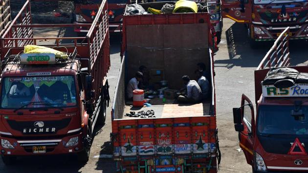Workers eat lunch in a parked truck at the APMC yard in Navi Mumbai on December 8. The IMD Mumbai regional director further said that while temperatures were high, December 8 saw a drop in humidity and the heat index (air temperature and relative humidity) was low as a result, indicating the perceived heat to be lower. (Indranil Mukherjee / AFP)