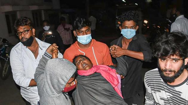 A woman showing symptoms of epilepsy being taken to a hospital in Eluru town of West Godavari district on December 6.(PTI)