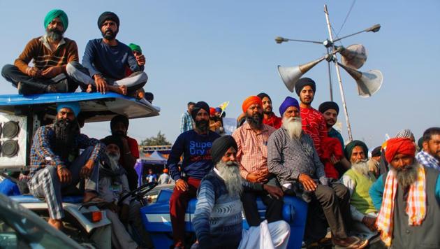Farmers sit on a tractor as they listen to a speaker during a protest against the newly passed farm bills at Singhu border near New Delhi, India, December 9, 2020.(Reuters photo)