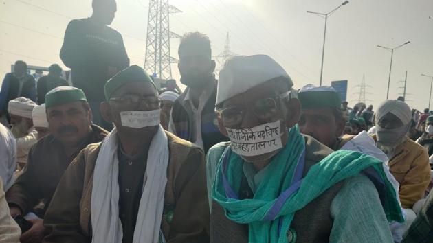 Chand and Prasad, both farmers from Uttar Pradesh, had taped their face with paper messages on them. (Fareeha Iftikhar/HT Photo) Chand and Prasad, both farmers from Uttar Pradesh, had taped their face with paper messages on them. (Fareeha Iftikhar/HT Photo)