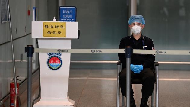 A security guard watches over the empty international arrivals channel at Beijing airport on November 6.(AFP)