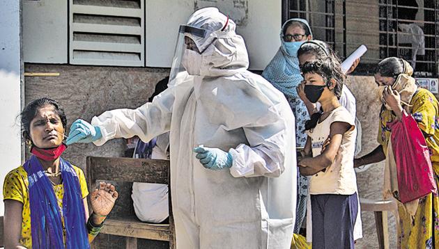 A health worker collects swab sample of a resident at Govandi in Mumbai on Wednesday. (Pratik Chorge/HT Photo) A health worker collects swab sample of a resident at Govandi in Mumbai on Wednesday. (Pratik Chorge/HT Photo)