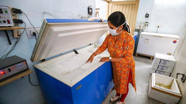 A medic checks the temperature of ice packs in a deep freezer at a Covid-19 vaccine storage facility in Ahmedabad.(PTI) A medic checks the temperature of ice packs in a deep freezer at a Covid-19 vaccine storage facility in Ahmedabad.(PTI)