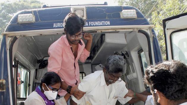A patient being helped out of an ambulance at a government hospital in Eluru in Andhra Pradesh.(PTI)