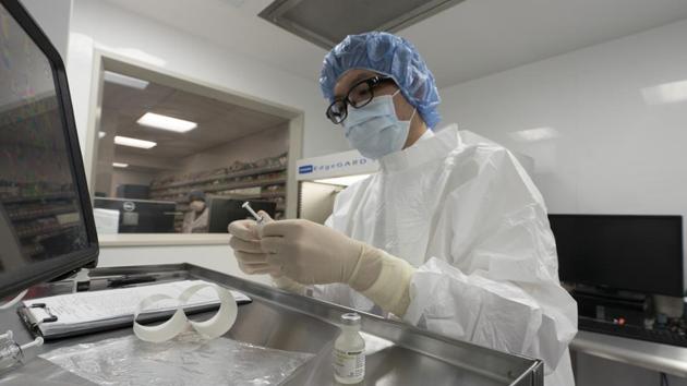 New York : A pharmacist labels syringes in a clean room where doses of COVID-19 vaccines will be handled, Wednesday, Dec. 9, 2020 at Mount Sinai Queens hospital in New York. The hospital expects to receive thousands of doses once a vaccine is approved. (AP) New York : A pharmacist labels syringes in a clean room where doses of COVID-19 vaccines will be handled, Wednesday, Dec. 9, 2020 at Mount Sinai Queens hospital in New York. The hospital expects to receive thousands of doses once a vaccine is approved. (AP)