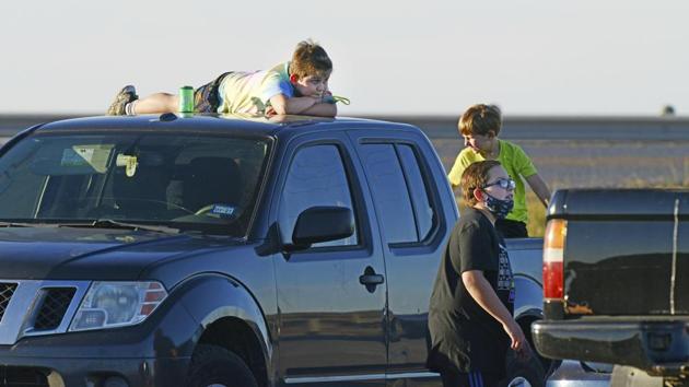 Youngsters wait to see SpaceX's prototype starship take off for a test flight on December 9 in Boca Chica. The self-guided rocket blew up as it touched down on a landing pad following a controlled descent. (Miguel Roberts/The Brownsville Herald via AP)